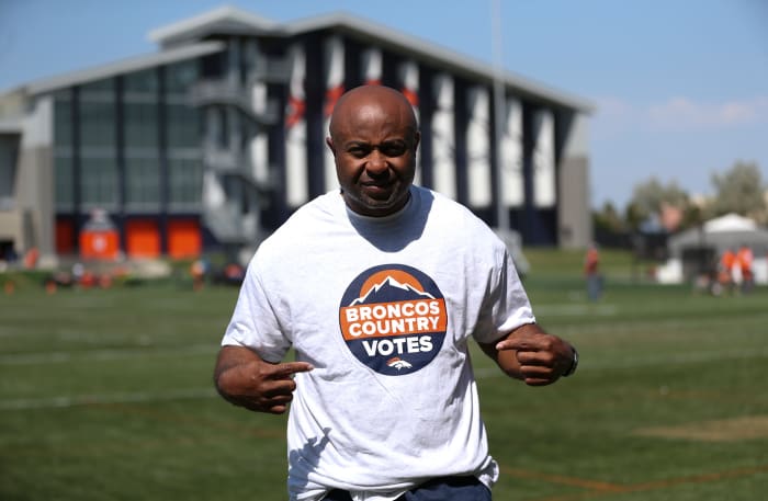 Portrait of Curtis Modkins, Broncos runnings backs coach, in a "Broncos Country Votes" t-shirt